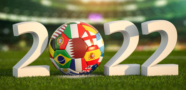 Football world championship 2022 in Qatar. Soccer ball with flags of world countries on the grass field of football stadium. .